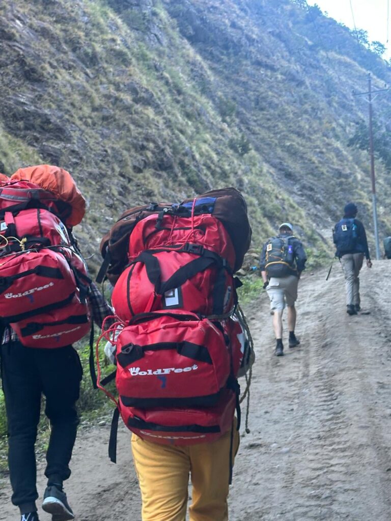 a porter from cold feet Adventure company on the trail